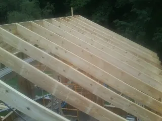 New roof rafters set over an addition before sheathing in Hamilton